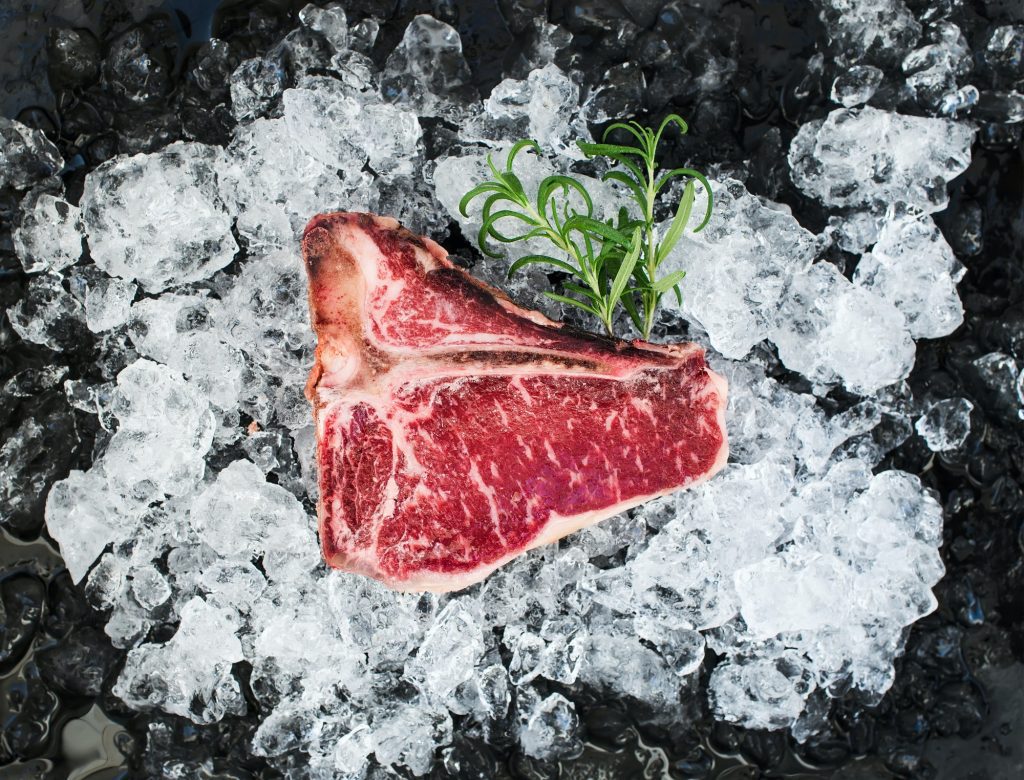 Raw fresh meat t-bone steak on chipped ice